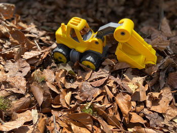 High angle view of yellow toy car on field