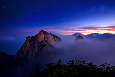 Scenic view of mountains against sky at sunset