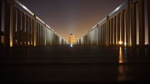 Illuminated bridge at night