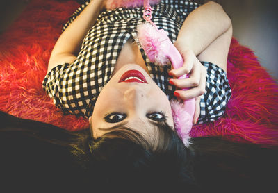 Portrait of woman relaxing on bed at home