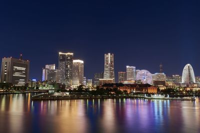 Illuminated city at waterfront