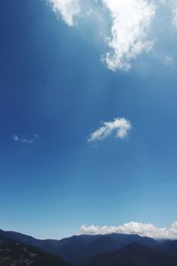 Low angle view of mountains against blue sky