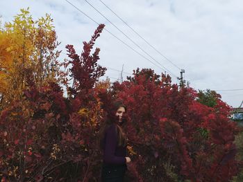 Portrait of teenage girl standing amidst plants
