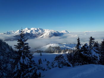 Scenic view of snowcapped mountains against clear blue sky