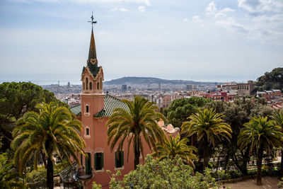 Panoramic view of trees and buildings against sky