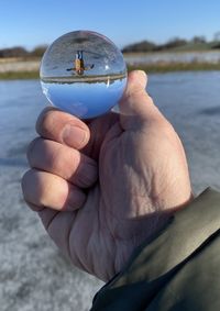 Close-up of hand holding crystal ball