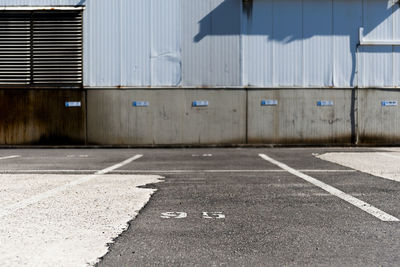 Empty road by buildings in city