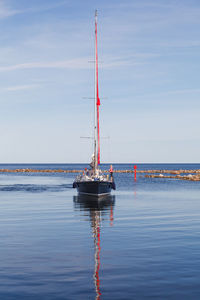 Sailboat on sea against sky