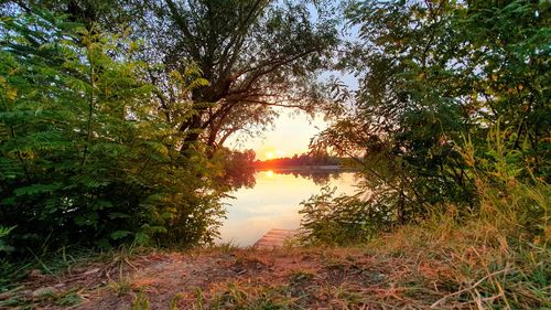 Scenic view of lake against sky at sunset