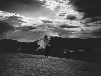 Silhouette of man against cloudy sky