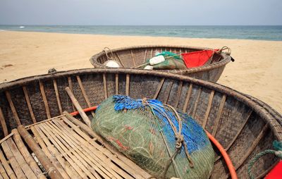 Fishing net on beach against blue sky