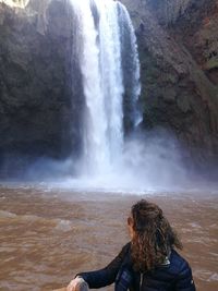 Woman looking at waterfall