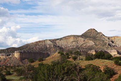 View of rocky mountains against cloudy sky