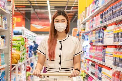 Portrait of woman wearing mask at shopping mall