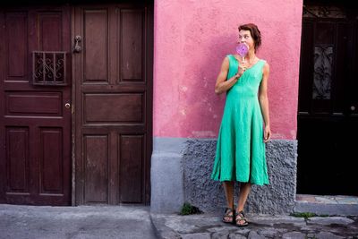 Full length of woman standing in front of door