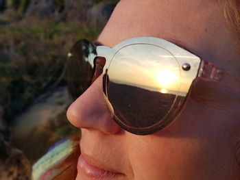 Close-up of woman holding sunglasses