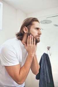 Bearded young man at domestic bathroom