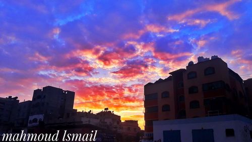 Low angle view of silhouette buildings against dramatic sky