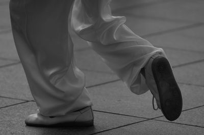 Low section of woman wearing high heels standing outdoors