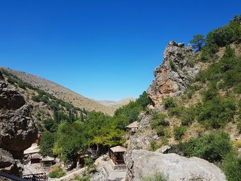 Scenic view of mountains against clear blue sky