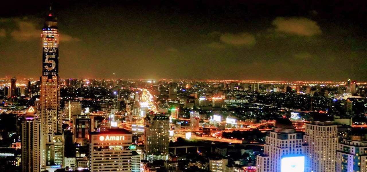 ILLUMINATED BUILDINGS AGAINST SKY AT NIGHT