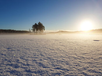 Scenic view of snowy landscape against sky during sunset