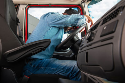 Rear view of man driving car