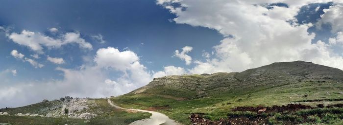 Scenic view of mountains against cloudy sky