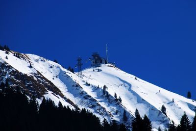 Scenic view of snowcapped mountains against clear blue sky