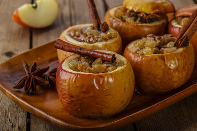 Close-up of stuffed baked apples in plate on table