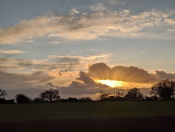 Scenic view of field against sky during sunset