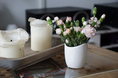 Close-up of white flower pot on table at home