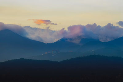 Scenic view of silhouette mountains against sky during sunset