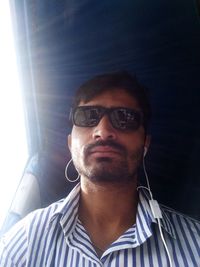 Close-up portrait of young man wearing sunglasses