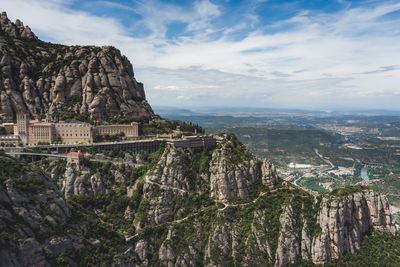 Scenic view of mountain against cloudy sky