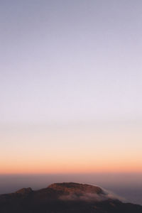 Scenic view of sea against clear sky during sunset