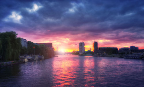 View of city at waterfront during sunset