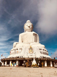 Statue of temple against cloudy sky