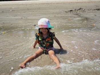 Full length portrait of smiling girl at beach