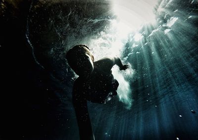 Low angle view of man swimming in sea