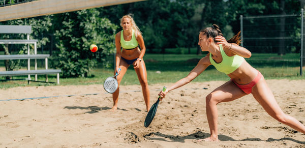 Beach tennis player hits the ball