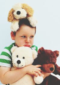 Cute boy with toys against white background