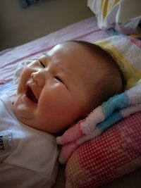 Close-up of baby sleeping in bed