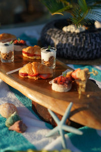 Close-up of cocktail food service on wooden plate serving for guests on yatch boat beach theme