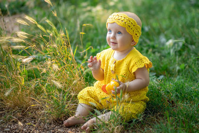 Portrait of cute girl standing on field