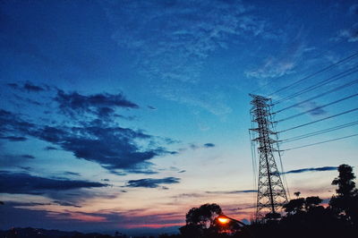 Low angle view of silhouette trees against sky at dusk