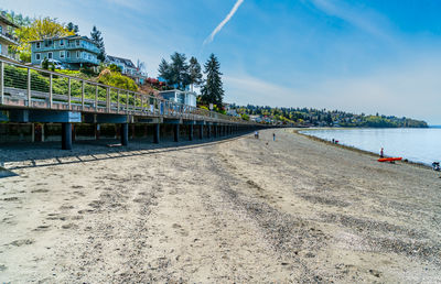 Pier on beach against sky