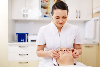 Close-up of woman getting beauty treatment from doctor