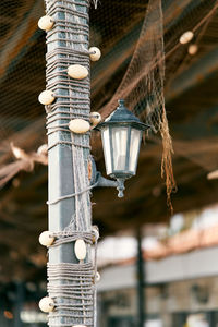 Low angle view of illuminated lighting equipment hanging on ceiling of building