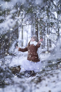 Woman standing on snow covered land